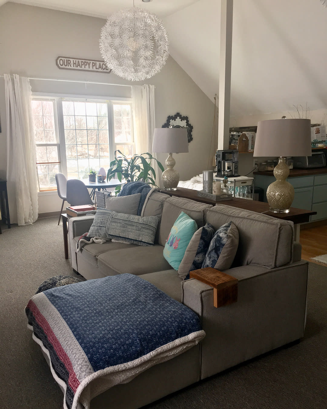 open plan living room kitchen gray sofa two lamps